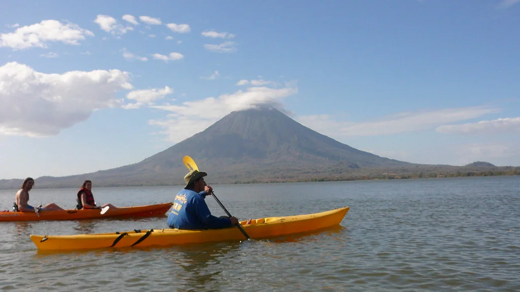Kayakers crossing open lake water toward Río Istián, with Concepción behind, photographed in February 2009