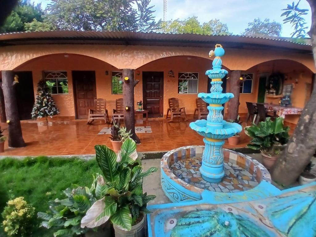 Blue courtyard fountain and covered terrace at Casa Caimana