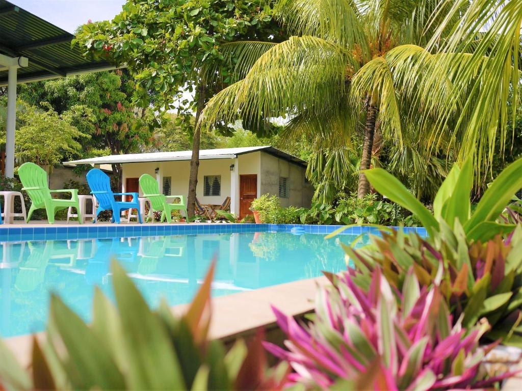 Swimming pool, garden planting and outdoor seating at Hospedaje Soma