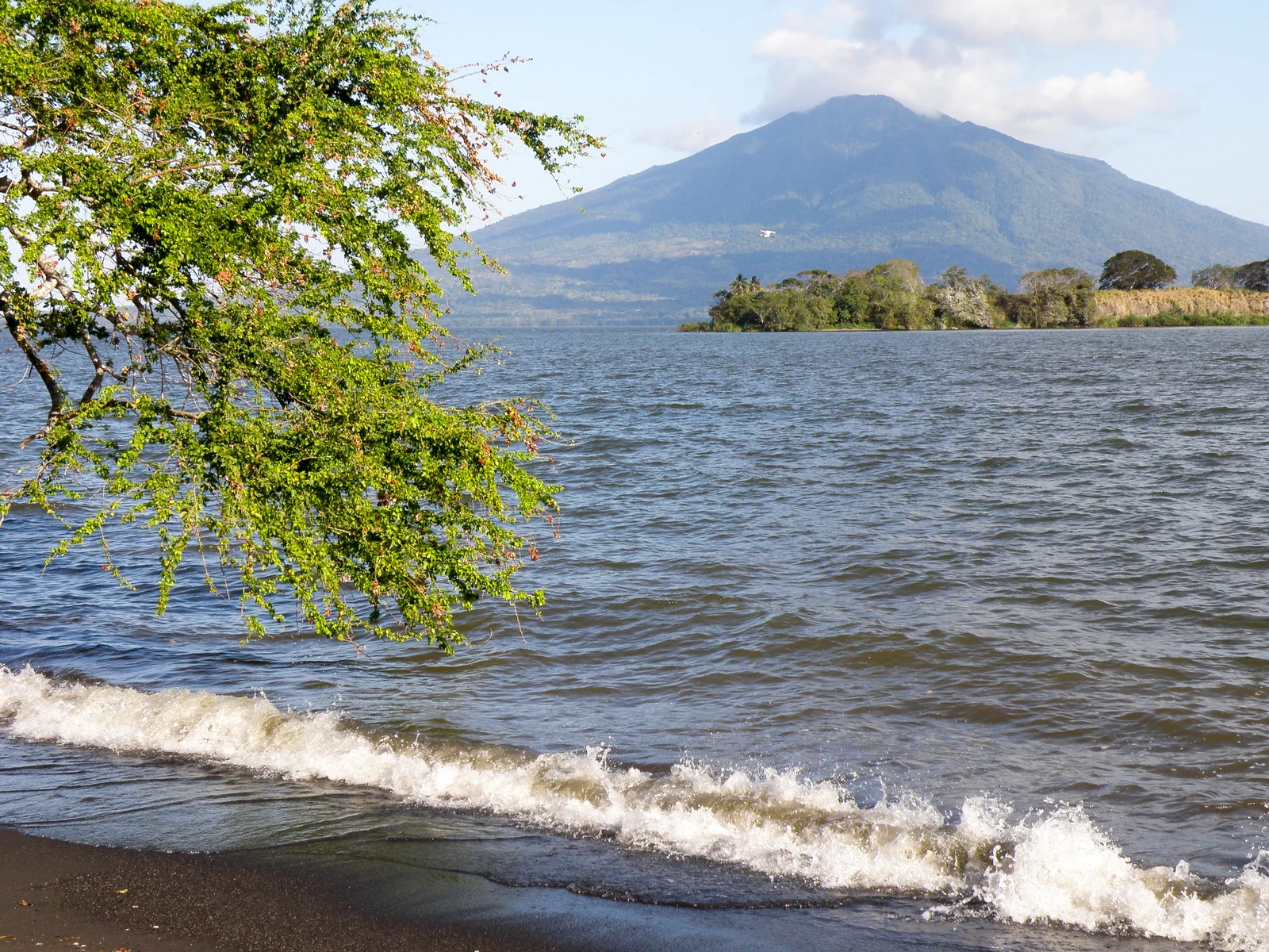 Maderas across Lake Nicaragua from Playa Bancón, with the wooded island of El Quiste in front